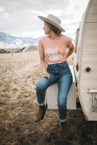 Woman sat on a caravan trailer wearing Free Thinker Shirt for Women by The Bee and The Fox