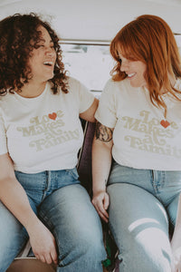 Two women in the back of a car wearing Love Makes a Family Shirt in Unisex by The Bee and The Fox