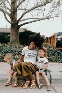 Woman sat on curb with two children wearing Love Your Mother Ringer Tee for Women by The Bee and The Fox