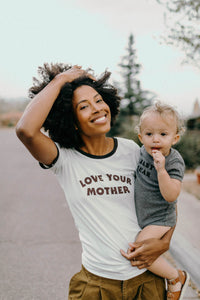 Woman holding a baby wearing Love Your Mother Ringer Tee for Women by The Bee and The Fox