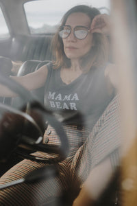 Woman sat behind wheel of a car wearing Mama Bear Muscle Tee by The Bee and The Fox