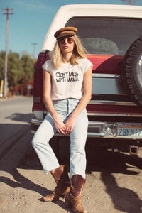 Woman leaning against a red truck wearing Don't Mess with Mama Shirt in Unisex by The Bee and The Fox