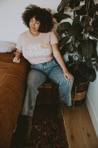 Woman sat next to a bed wearing Free Thinker Shirt for Women by The Bee and The Fox