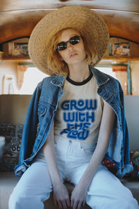 Woman sat in a campervan wearing a hat and Grow with the Flow Ringer Tee for Women by The Bee and The Fox