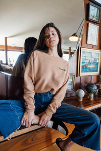 Woman sat in front of a mirror in Cropped Mamacita Sweatshirt for Women by The Bee and The Fox