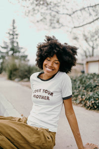 Woman sat on curb wearing Love Your Mother Ringer Tee for Women by The Bee and The Fox