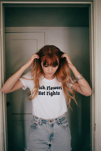 Woman stood in a door way in White Pick Flowers Not Fights Shirt for Women by The Bee and The Fox
