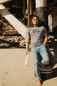 Man leaning on pier wearing Papa Bear Shirt for Men in gray by The Bee and The Fox